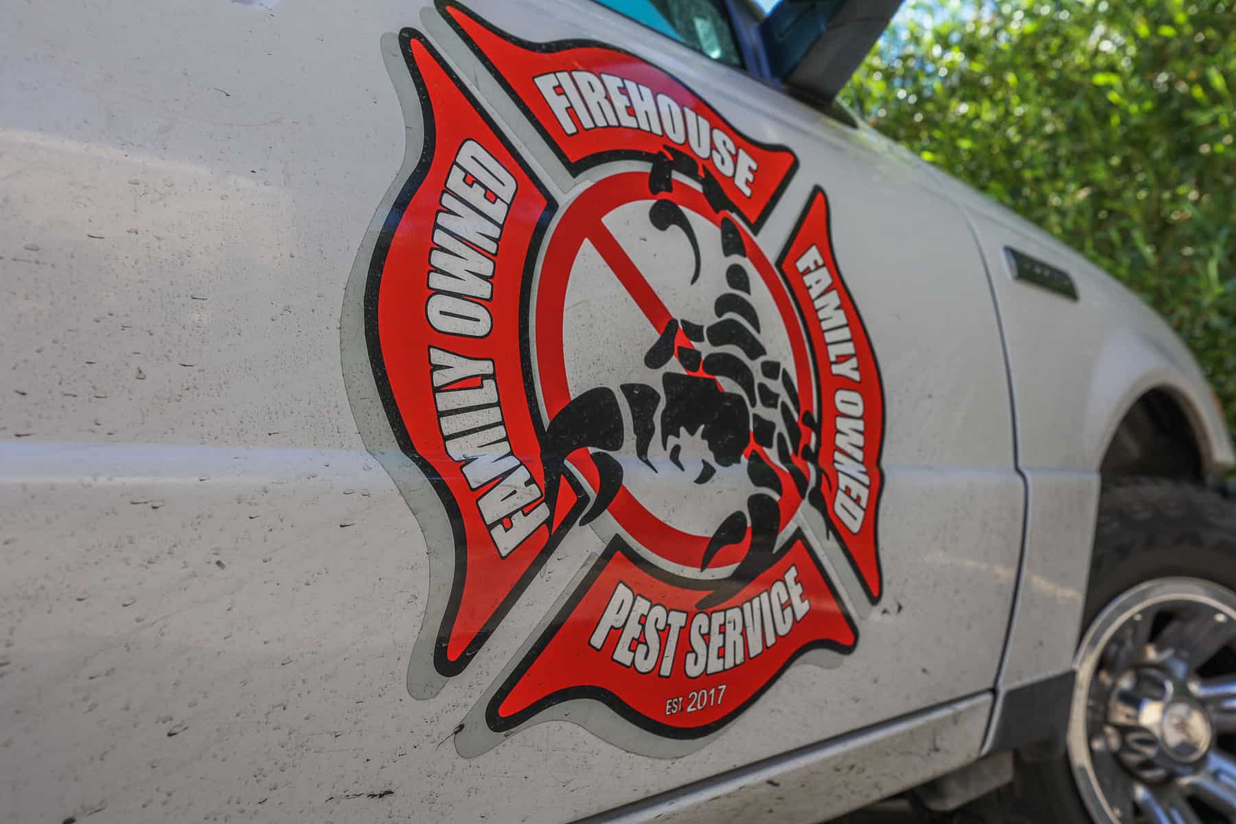 Firehouse Pest Control Services badge on a service truck